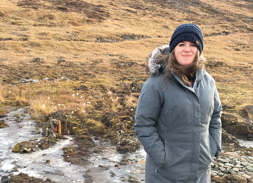 Emily standing on a snowy ground and ice in Svalbard